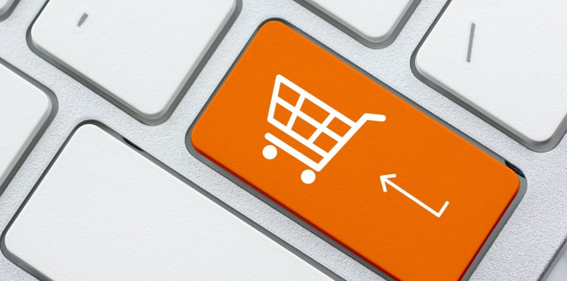 An orange add to cart button on a computer keyboard.